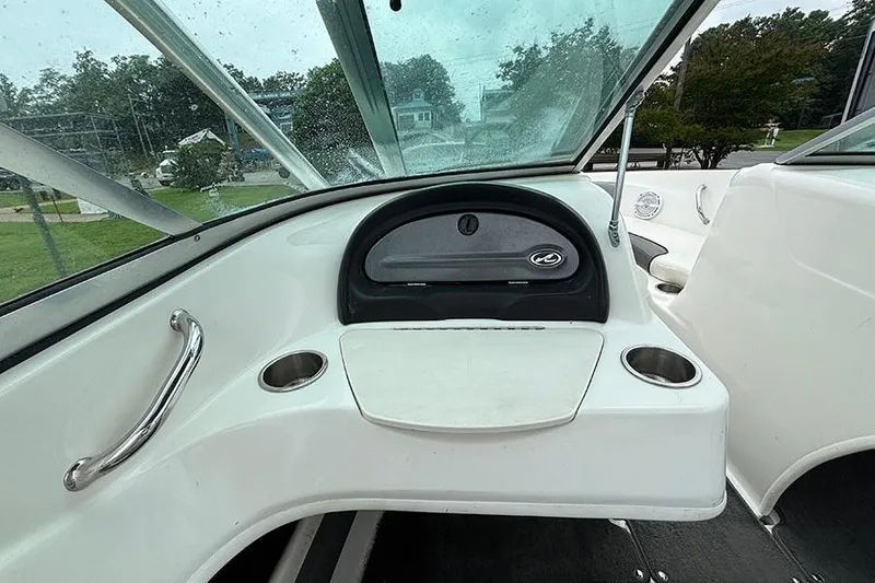 Slide: The Image of Interior view of a 2011 Sea Ray 205 Sport boat dashboard with cup holders. - 16