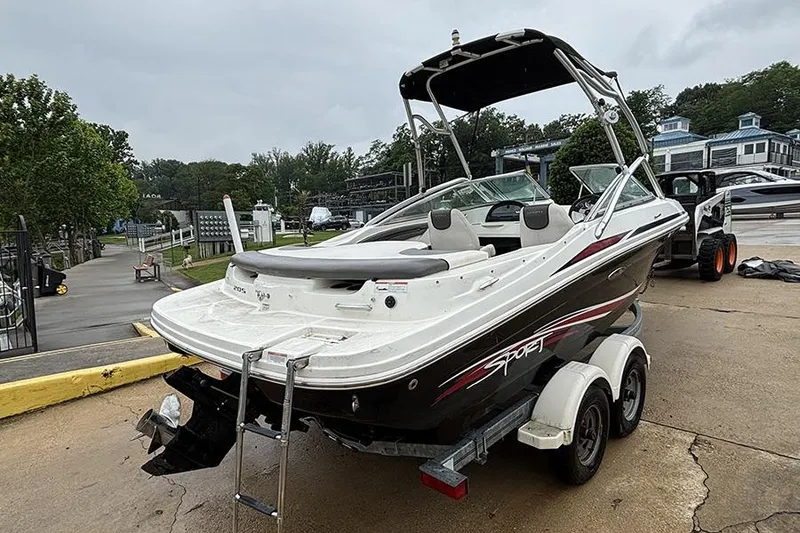 Slide: The Image of 2011 Sea Ray 205 Sport boat on trailer, parked outdoors near marina. - 7