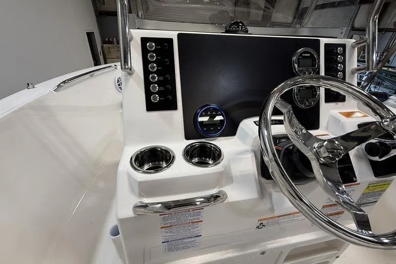 Slide: The Image of 2026 Robalo R180 Center Console with modern helm and stainless steel features. - 11