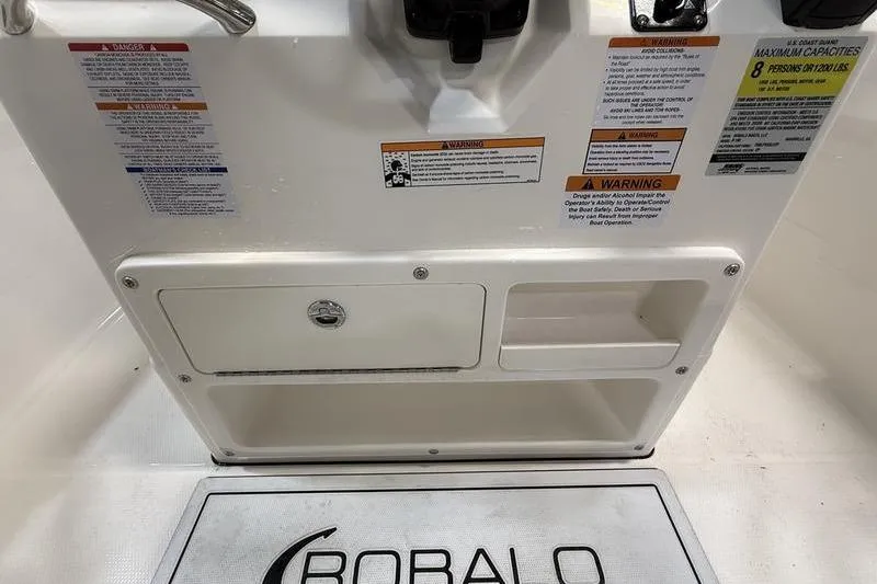 Slide: The Image of Robalo R180 Center Console 2026 with warning labels and storage compartment. - 12