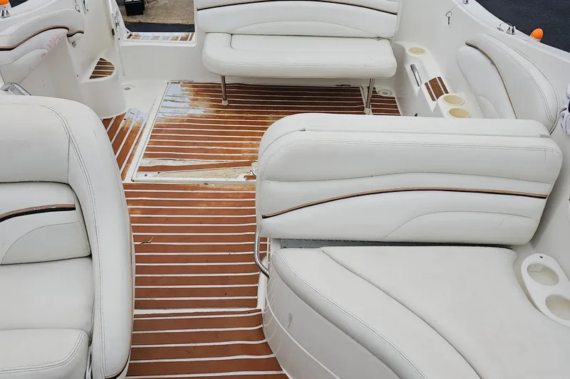 Slide: The Image of Interior of 2002 Wellcraft 2600 Martinique boat with white seating and wood flooring. - 11
