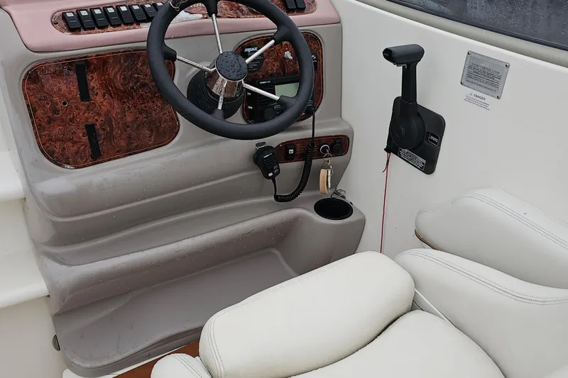 Slide: The Image of 2002 Wellcraft 2600 Martinique boat helm with steering wheel and control panel. - 12