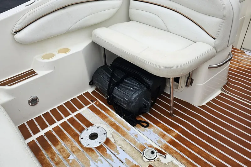 Slide: The Image of 2002 Wellcraft 2600 Martinique boat interior with white seating and wooden flooring. - 20