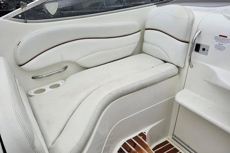 Slide: The Image of 2002 Wellcraft 2600 Martinique boat interior with white cushioned seating and cup holders. - 21