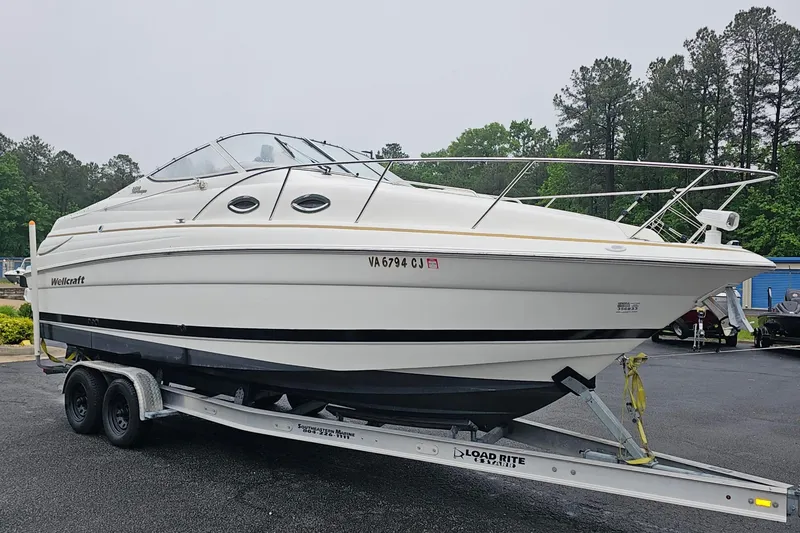 Slide: The Image of 2002 Wellcraft 2600 Martinique boat on trailer outdoors. - 4