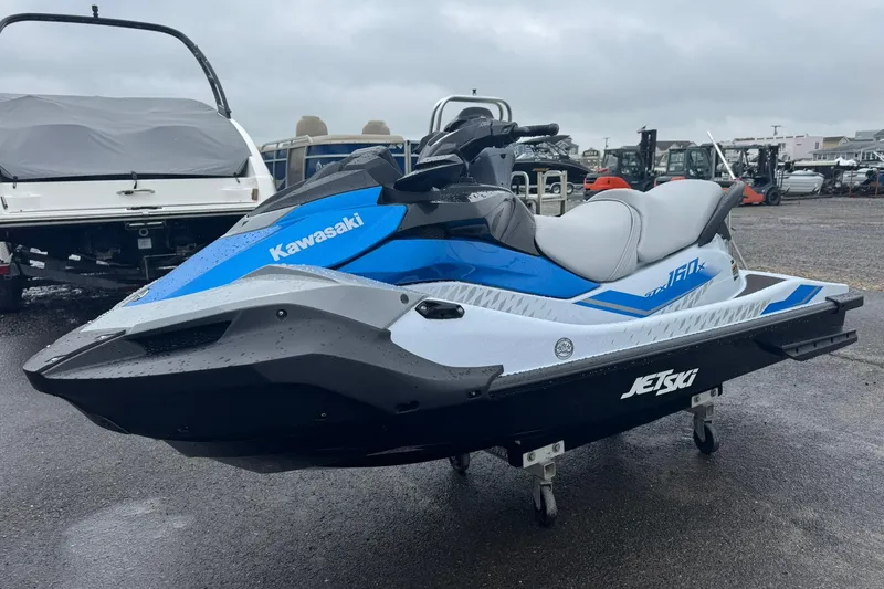 The Image of 2026 Kawasaki STX160X Jetski in a parking lot. - 1