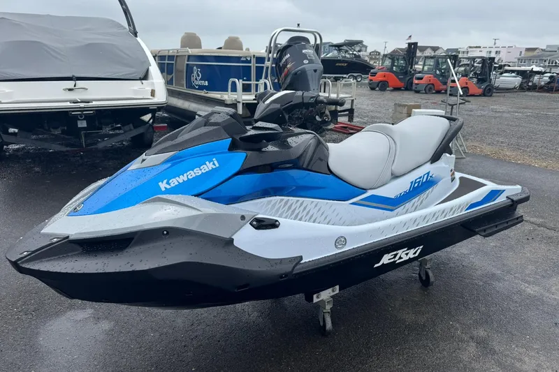 Slide: The Image of 2026 Kawasaki STX160 Jet Ski in blue and white, parked on a trailer. - 3
