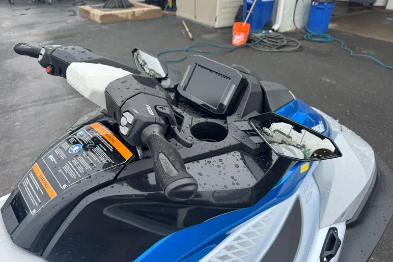Slide: The Image of 2026 Kawasaki STX160 jet ski dashboard with raindrops, featuring handlebars and mirrors. - 4