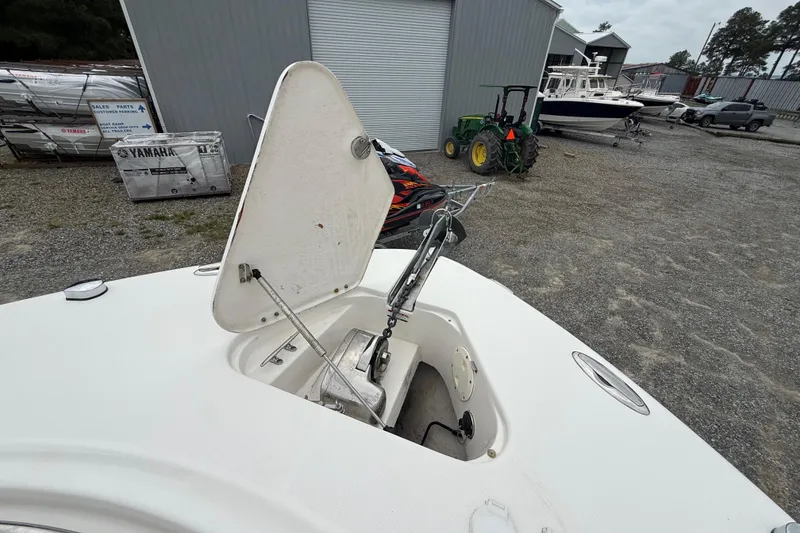 Slide: The Image of 2008 Robalo R300 Center Console boat anchor compartment open in a storage yard. - 10