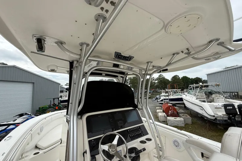 Slide: The Image of 2008 Robalo R300 Center Console boat interior with steering wheel and control panel. - 16