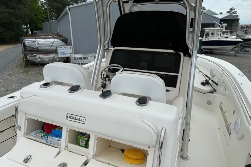 Slide: The Image of 2008 Robalo R300 Center Console boat interior with helm and storage compartments. - 17