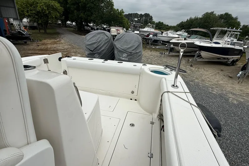 Slide: The Image of 2008 Robalo R300 Center Console boat with covered engines in a marina setting. - 18