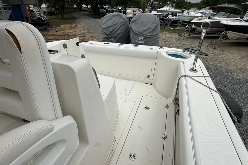 Slide: The Image of 2008 Robalo R300 Center Console boat interior with covered engines and seating area. - 21
