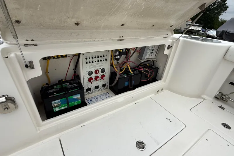 Slide: The Image of 2008 Robalo R300 Center Console boat electrical panel and battery compartment. - 22