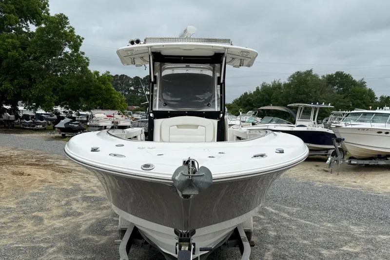 Slide: The Image of 2008 Robalo R300 Center Console boat on display in a marina setting. - 25