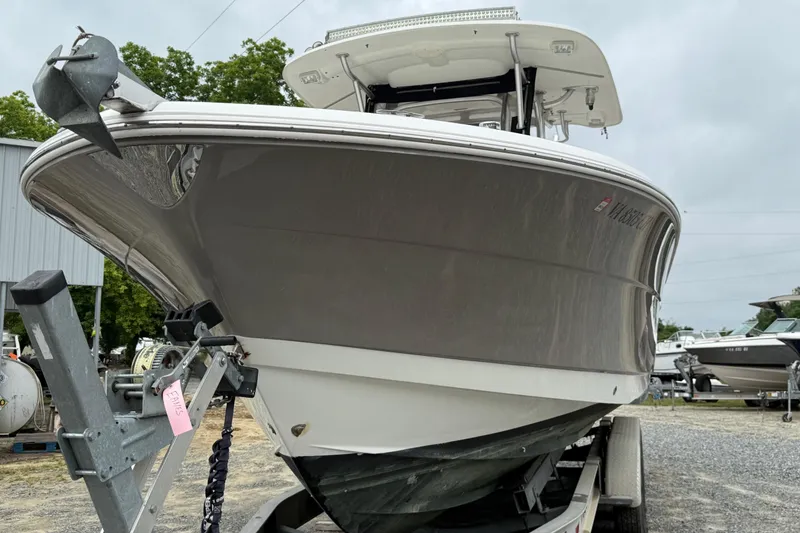 Slide: The Image of 2008 Robalo R300 Center Console boat on trailer, displayed outdoors. - 26