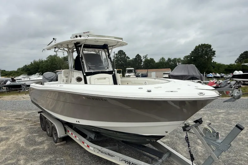 Slide: The Image of 2008 Robalo R300 Center Console boat on a trailer in a marina setting. - 27