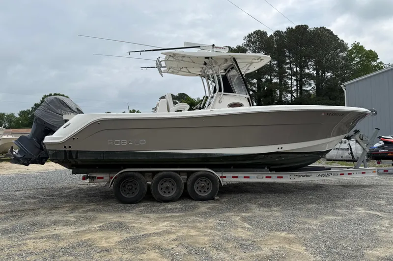 Slide: The Image of 2008 Robalo R300 Center Console boat on trailer, parked outdoors. - 28