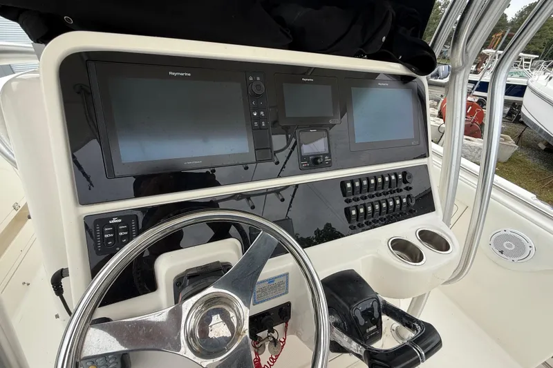 Slide: The Image of 2008 Robalo R300 Center Console dashboard with navigation screens and controls. - 5