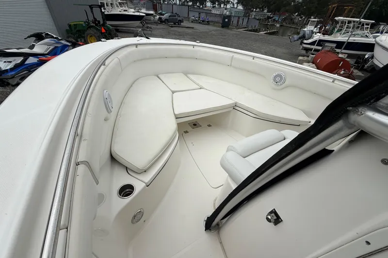 Slide: The Image of 2008 Robalo R300 Center Console boat interior with white cushioned seating. - 6