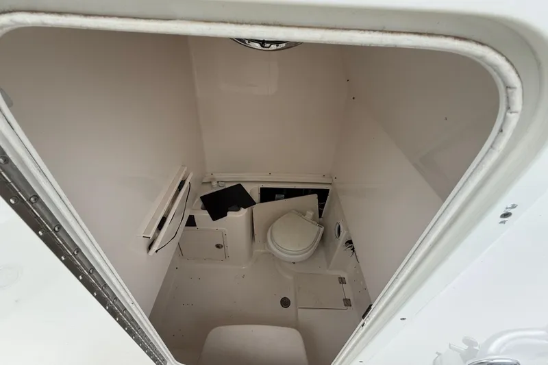 Slide: The Image of 2008 Robalo R300 Center Console boat interior with compact marine toilet. - 7