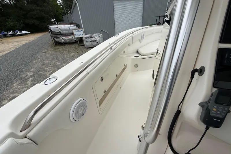 Slide: The Image of 2008 Robalo R300 Center Console boat interior with stainless steel railings and storage compartments. - 8