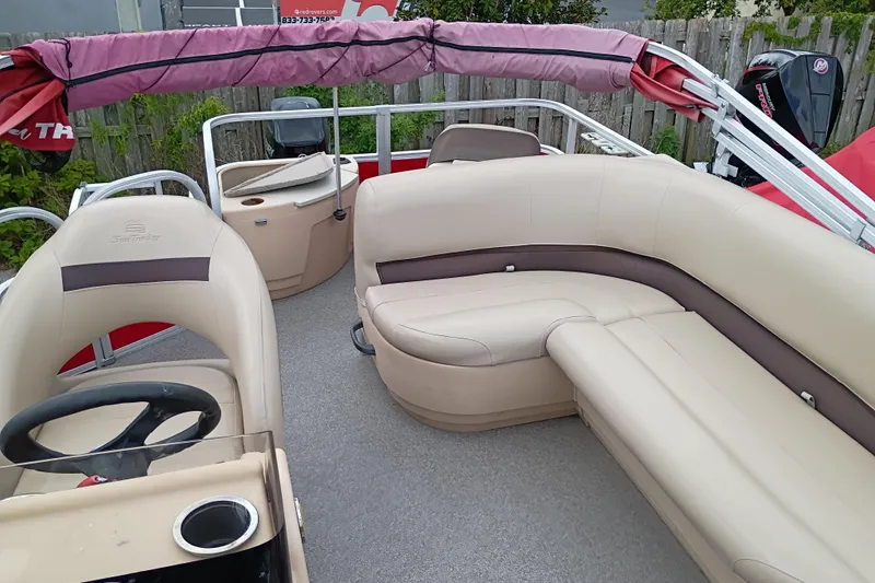 Slide: The Image of 2017 Sun Tracker Bass Buggy 18 DLX pontoon boat with beige seating and steering console. - 3