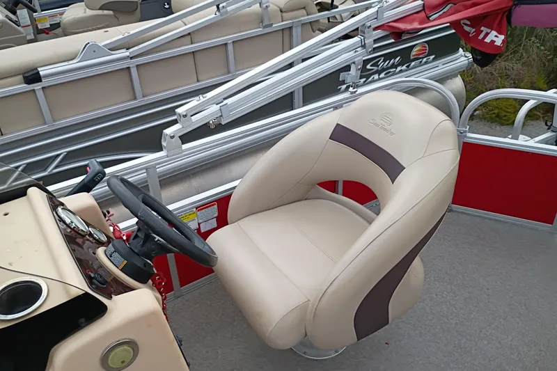 Slide: The Image of 2017 Sun Tracker Bass Buggy 18 DLX boat interior with steering wheel and captain's chair. - 4