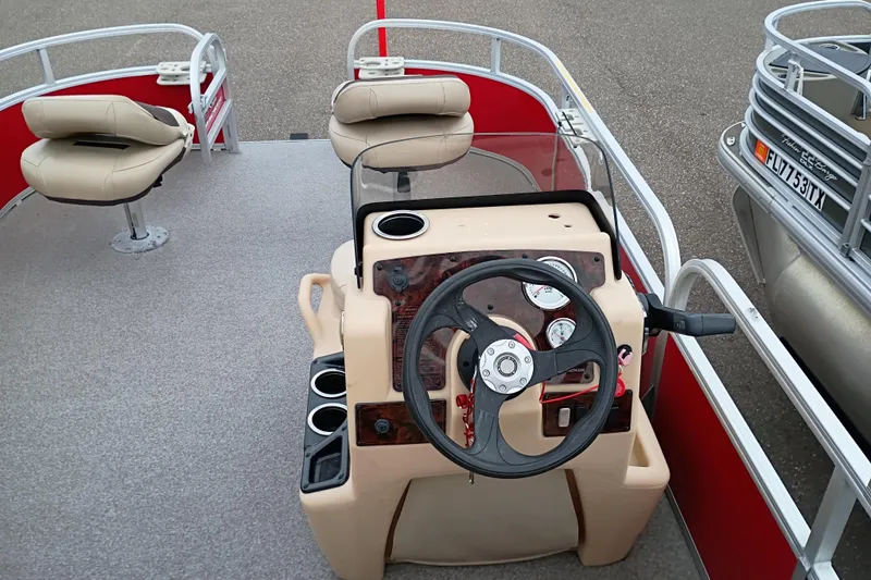 Slide: The Image of 2017 Sun Tracker Bass Buggy 18 DLX pontoon boat interior with steering console and seating. - 5