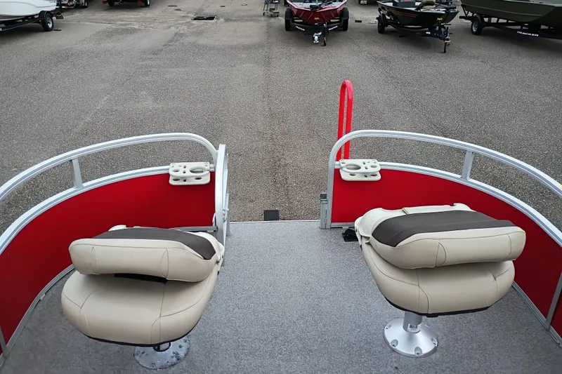 Slide: The Image of 2017 Sun Tracker Bass Buggy 18 DLX pontoon boat with beige seats and red railing. - 6