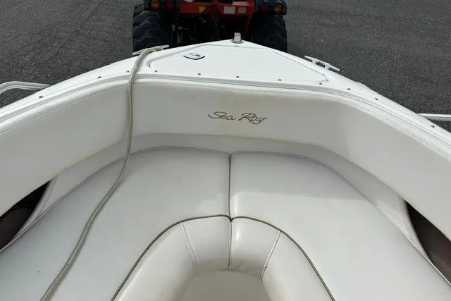 Slide: The Image of 1998 Sea Ray 210 Bow Rider boat with white interior. - 10