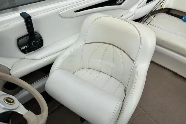 Slide: The Image of Interior of a 1998 Sea Ray 210 Bow Rider boat with white seating. - 13