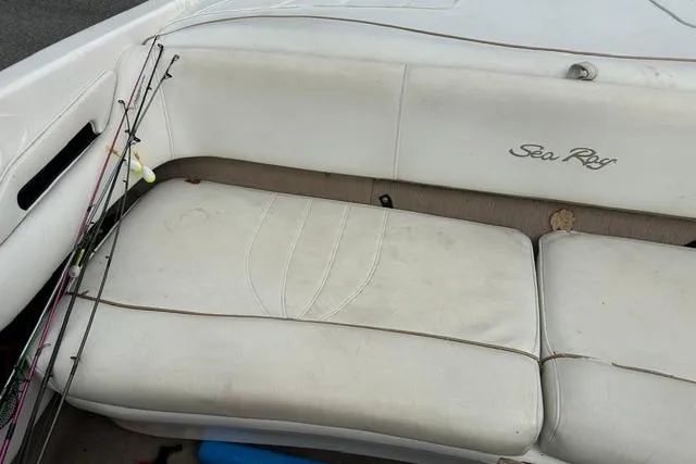 Slide: The Image of Interior of a 1998 Sea Ray 210 Bow Rider boat with white seats. - 16
