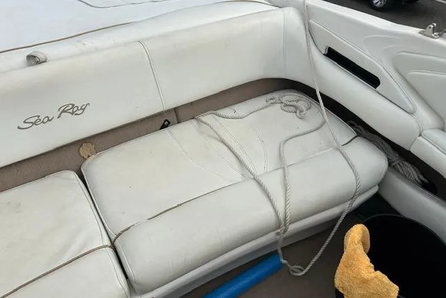Slide: The Image of Interior of a 1998 Sea Ray 210 Bow Rider with white seating. - 17