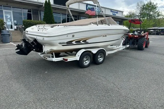 Slide: The Image of 1998 Sea Ray 210 Bow Rider on trailer outside a store. - 4