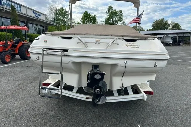 Slide: The Image of Rear view of a 1998 Sea Ray 210 Bow Rider boat in a parking lot. - 5