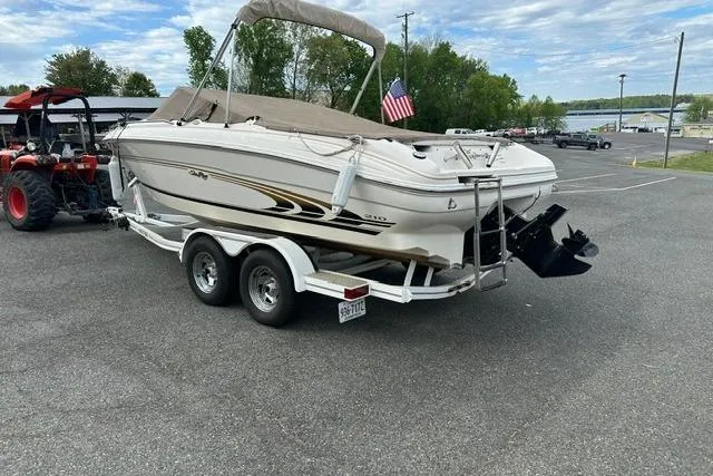 Slide: The Image of 1998 Sea Ray 210 Bow Rider on trailer, parked outdoors. - 8