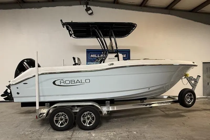 The Image of 2026 Robalo R200 Center Console boat on trailer in indoor showroom. - 0
