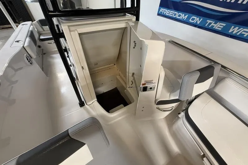 Slide: The Image of 2026 Robalo R200 Center Console boat interior with open storage compartment. - 15