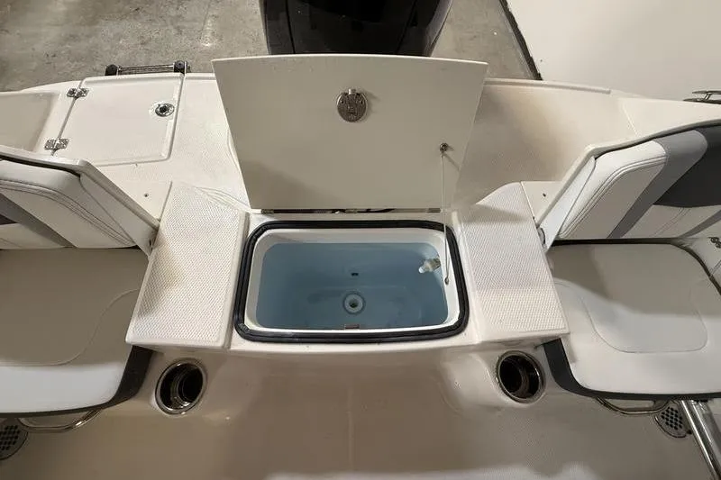 Slide: The Image of 2026 Robalo R200 Center Console boat interior with open storage compartment. - 6
