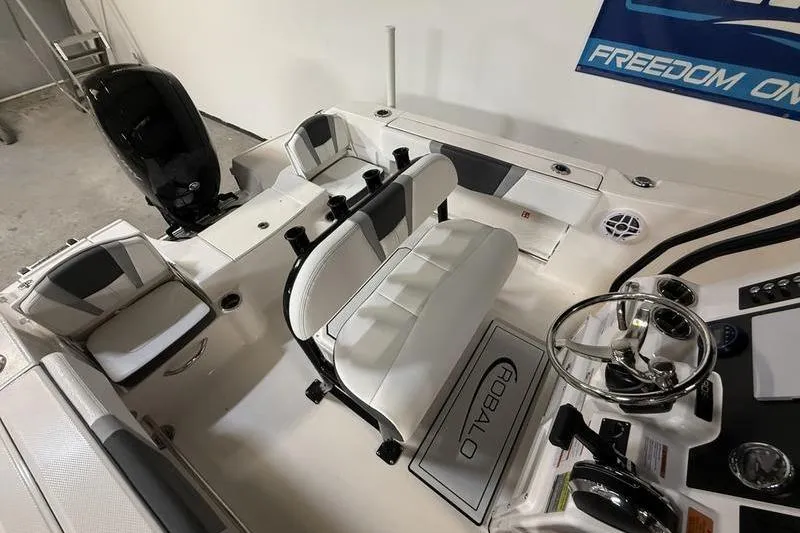 Slide: The Image of 2026 Robalo R200 Center Console boat interior with seating and steering wheel. - 7