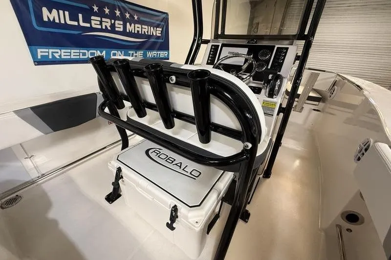 Slide: The Image of 2026 Robalo R200 Center Console boat interior with fishing rod holders and control panel. - 8