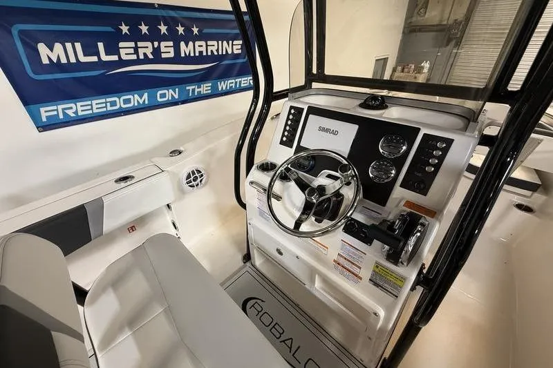 Slide: The Image of 2026 Robalo R200 Center Console boat interior with steering wheel and controls. - 9