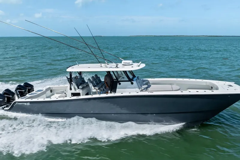 The Image of Freeman 42LR 2020 boat cruising on open water with fishing rods and outboard motors. - 0