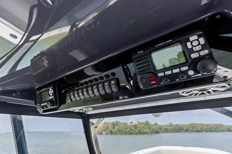 Slide: The Image of Control panel of a 2020 Freeman 42LR boat with marine radio and switches. - 16