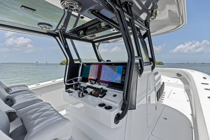 Slide: The Image of Luxury Freeman 42LR boat cockpit with advanced navigation system, 2020 model, on calm waters. - 19