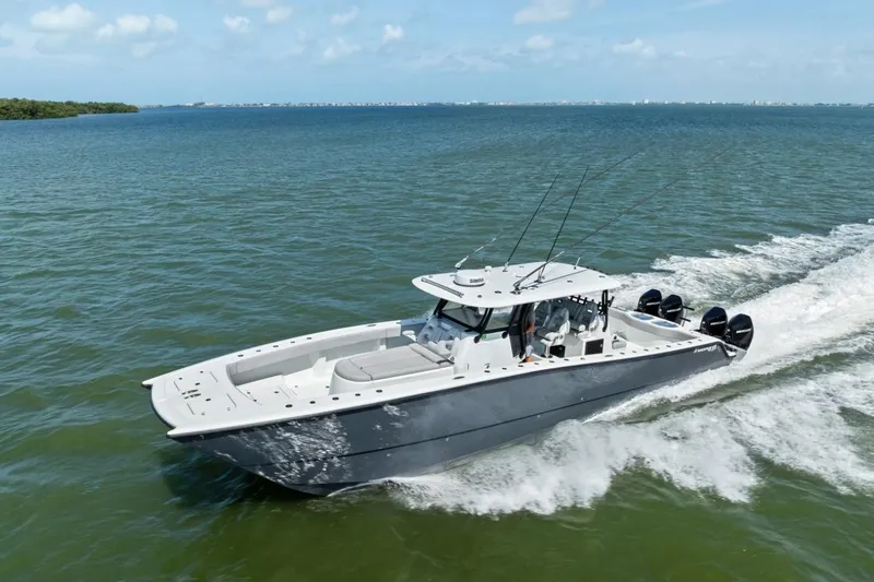 Slide: The Image of 2020 Freeman 42LR boat cruising on open water under a clear blue sky. - 2