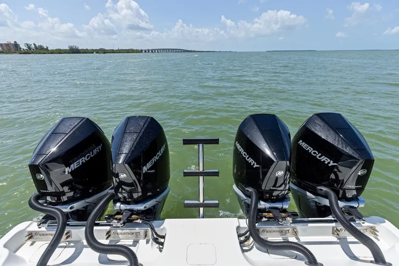 Slide: The Image of Four Mercury outboard engines on a 2020 Freeman 42LR boat in open water. - 27