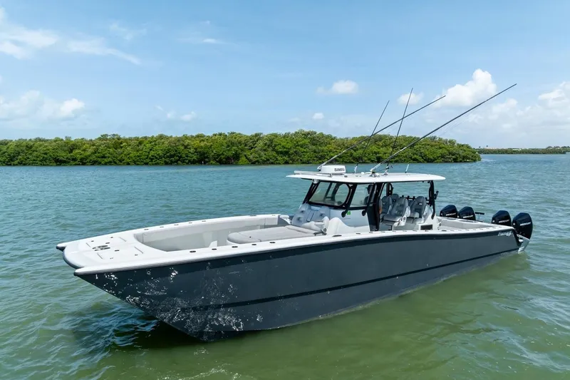 Slide: The Image of 2020 Freeman 42LR boat on calm water with lush green island background. - 3