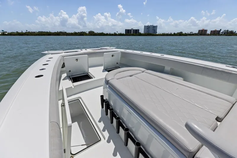 Slide: The Image of 2020 Freeman 42LR boat interior with seating and storage compartments on calm water. - 33